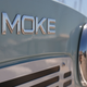 A photo of the Moke badge on the front of an EV>